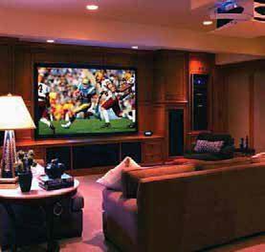 Home theatre room with football game on screen